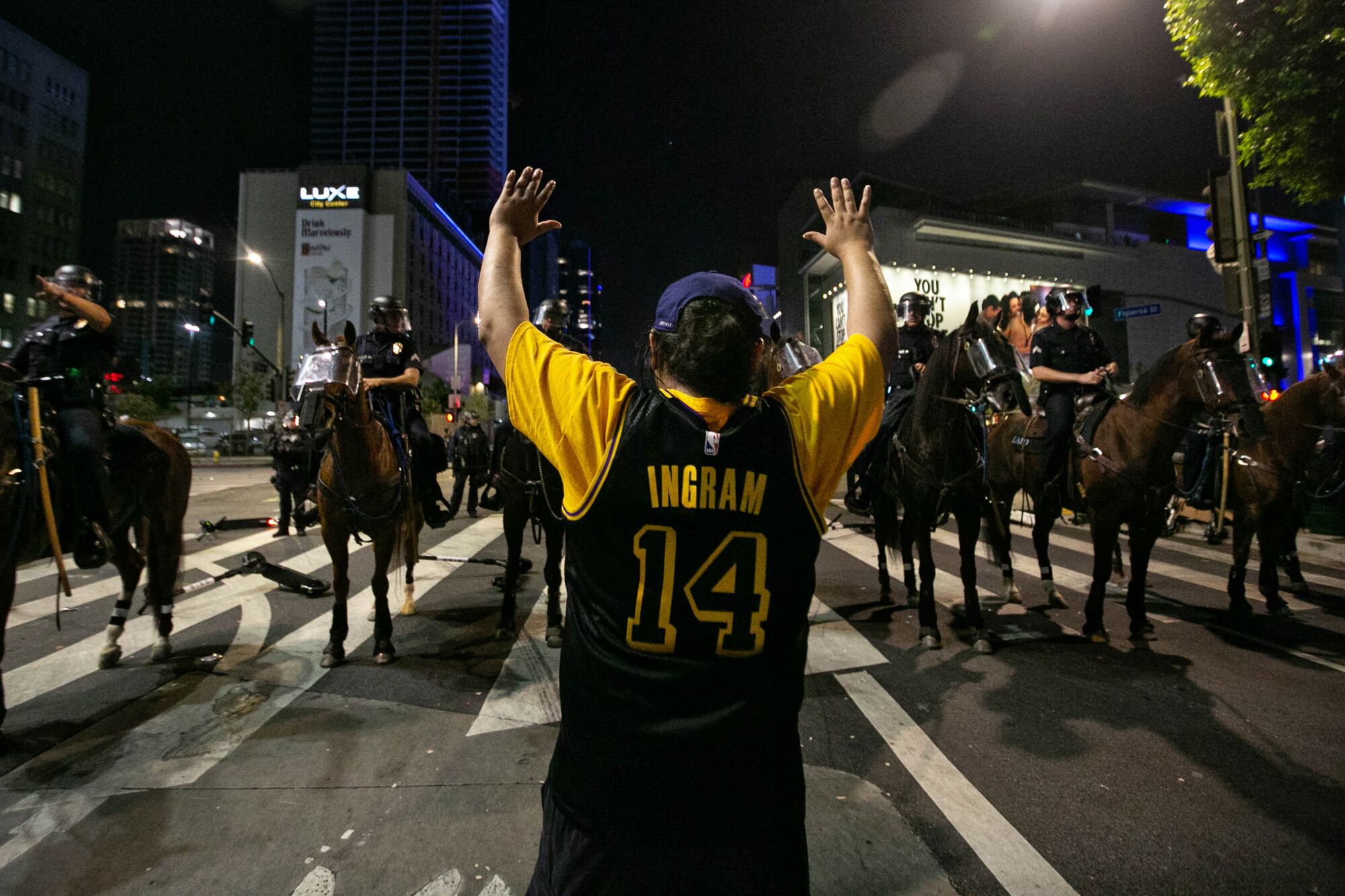LAPD officers on horses clear the area near L.A. Live, declaring an unlawful assembly, after the Lakers’ win over the Miami

