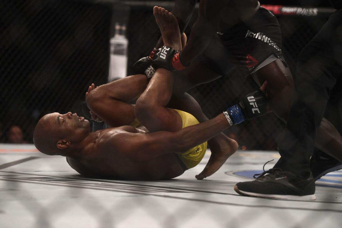 Brazilian fighter Anderson Silva reacts inside the octagon after injuring his knee during the fight against US fighter Jared Cannonier at their men's middleweight bout at the Ultimate Fighting Championship 237 event (UFC 237) at Jeunesse Arena in Rio de Janeiro on May 11, 2019.