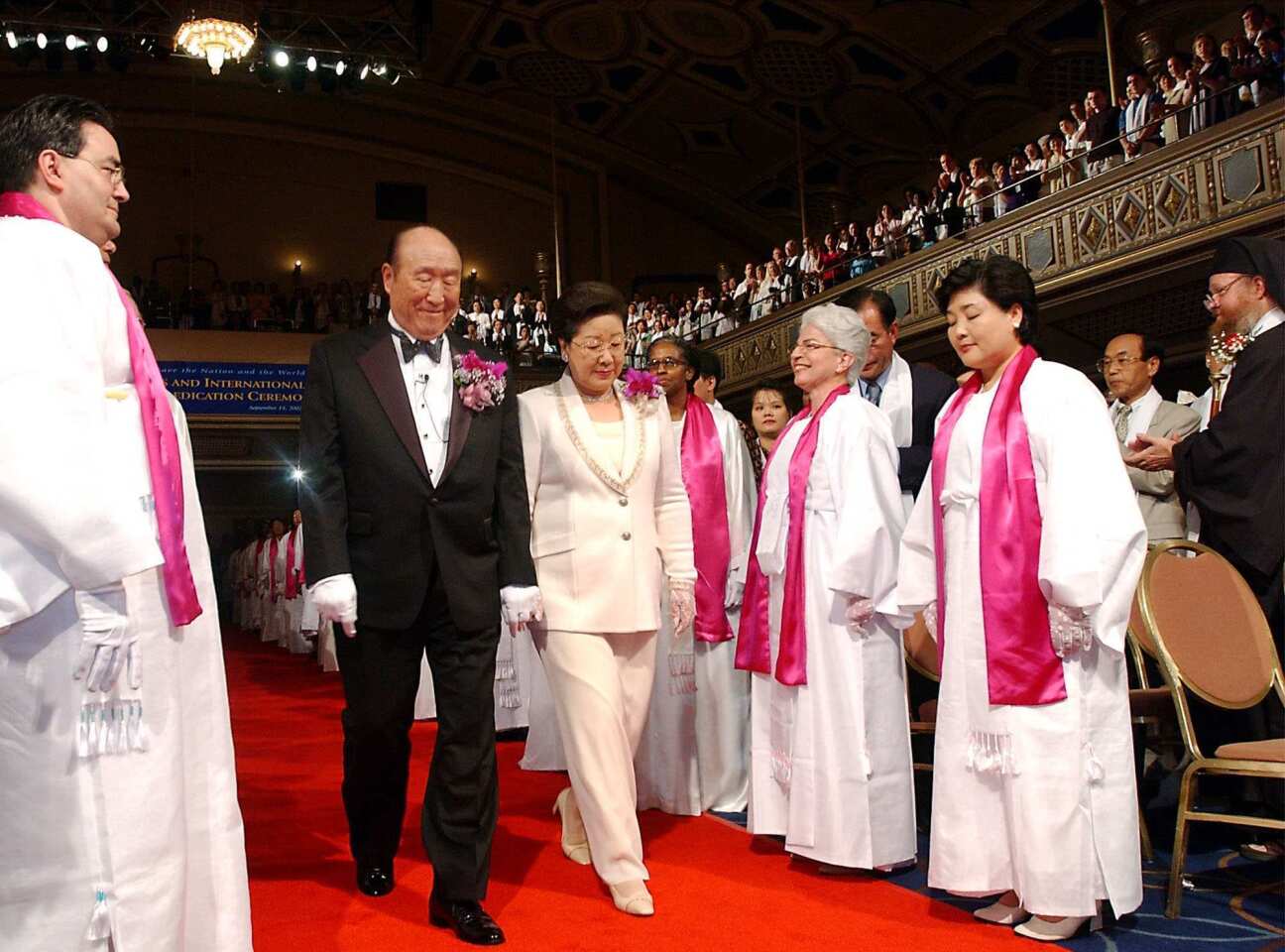 The Rev. Sun Myung Moon and his wife, Hak Ja Han, walk down a red carpet as they are introduced during the Affirmation of Vows part of the Interreligious and International Couple's Blessing and Rededication Ceremony at New York's Manhattan Center. About 500 to 600 couples participated in New York, and an estimated 21 million couples participated worldwide via a simulcast to 185 countries.