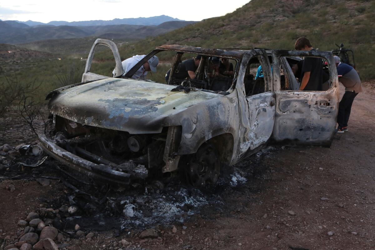 The burned-out shell of a car occupied by one of the Mormon families attacked Monday by suspected drug cartel members in Sonora, Mexico.