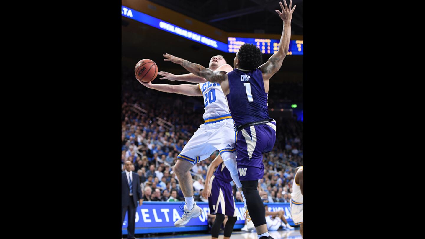 UCLA guard Bryce Alford drives to the basket against Washington's David Crisp during the first half.