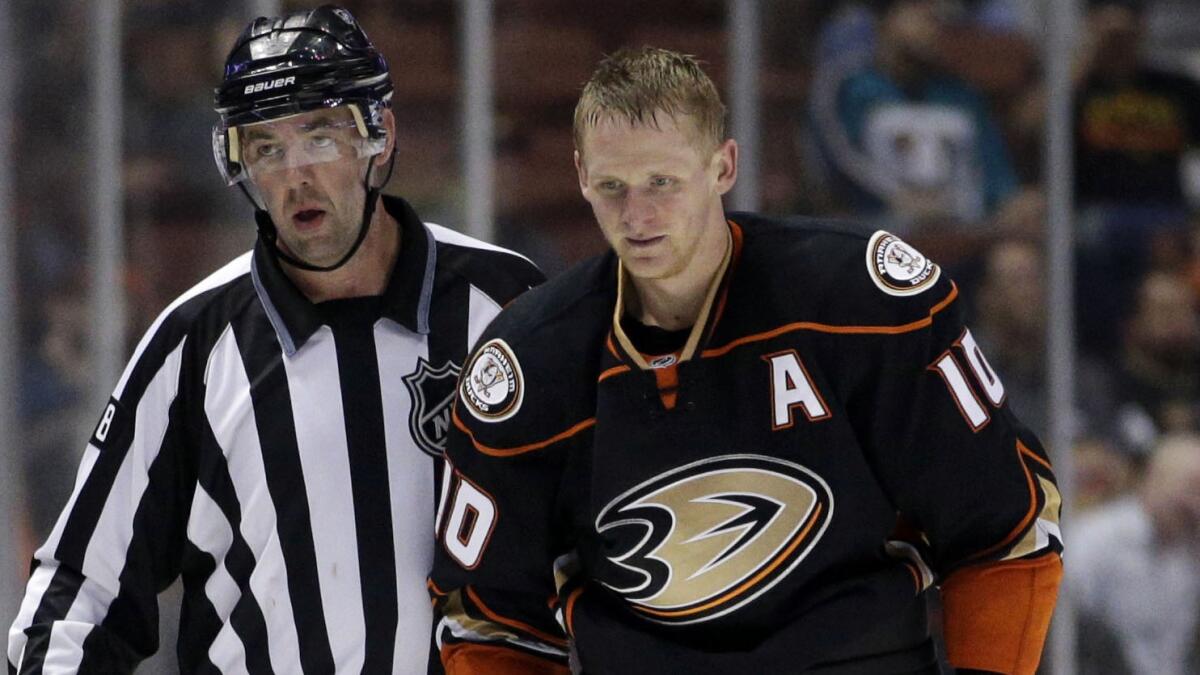 Anaheim Ducks' Corey Perry, right, is escorted off the ice by linesman Brian Mach after receiving a misconduct penalty against the San Jose Sharks on Oct. 26.