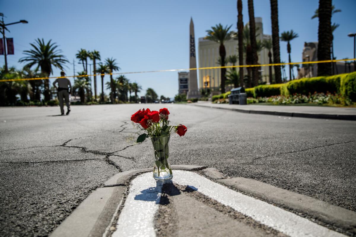 Flowers are left near the site of the Las Vegas massacre. California Atty. General Xavier Becerra issued a consumer alert Wednesday warning the public about scam charities after the mass shooting.