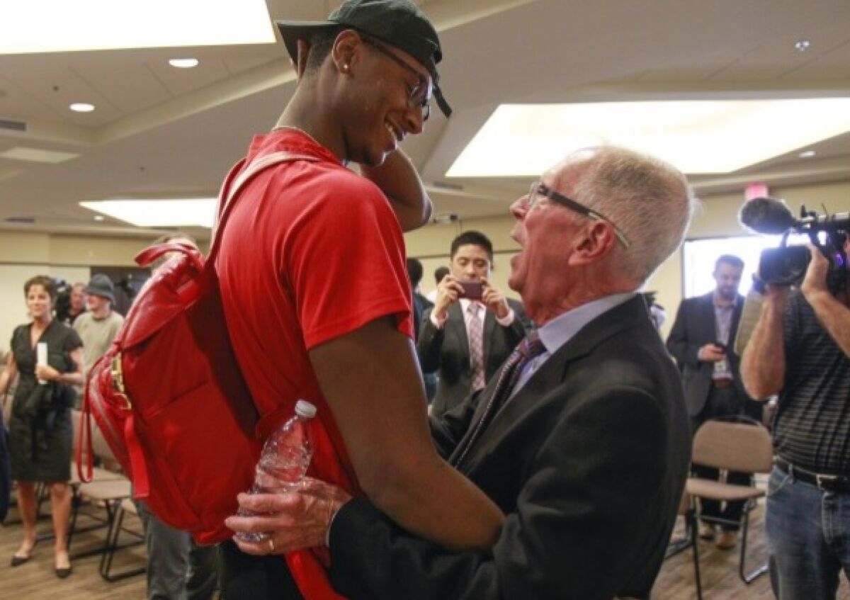 In April 2017 Steve Fisher retired as Azecs basketball coach and Brian Dutcher took over. He hugs past player Skylar Spencer.