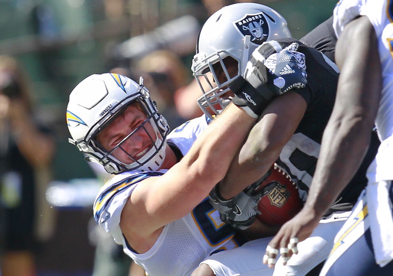 San Diego Chargers Joey Bosa stops Raiders Jalen Richard in the 2nd quarter in Oakland on Oct. 9, 2016. (Photo by K.C. Alfred/The San Diego Union-Tribune)