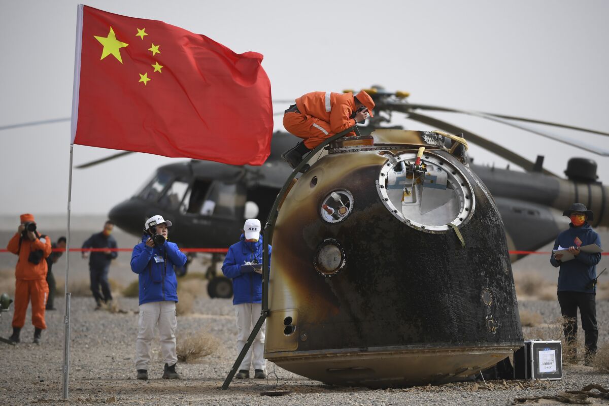 In this photo released by China's Xinhua News Agency, the return capsule of the Shenzhou-13 manned space mission is seen after landing at the Dongfeng landing site in northern China's Inner Mongolia Autonomous Region, Saturday, April 16, 2022. Three Chinese astronauts returned to Earth on Saturday after six months aboard China's newest space station in the longest crewed mission to date for its ambitious space program. (Peng Yuan/Xinhua via AP)