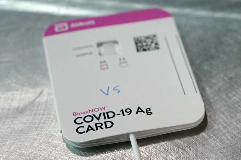 FILE - This Wednesday, Feb. 3, 2021 file photo shows a BinaxNOW rapid COVID-19 test made by Abbott Laboratories, in Tacoma, Wash. On Wednesday, March 31, 2021, the FDA said Abbott’s BinaxNow and Quidel’s QuickVue tests can now be sold without a prescription for consumers to test themselves repeatedly at home. (AP Photo/Ted S. Warren)