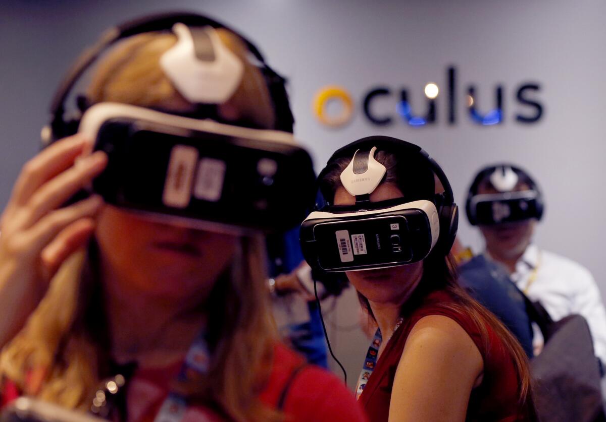 Video game enthusiasts try out the Samsung VR powered by Oculus virtual reality goggles at the E3 annual video game conference in Los Angeles on June 16.