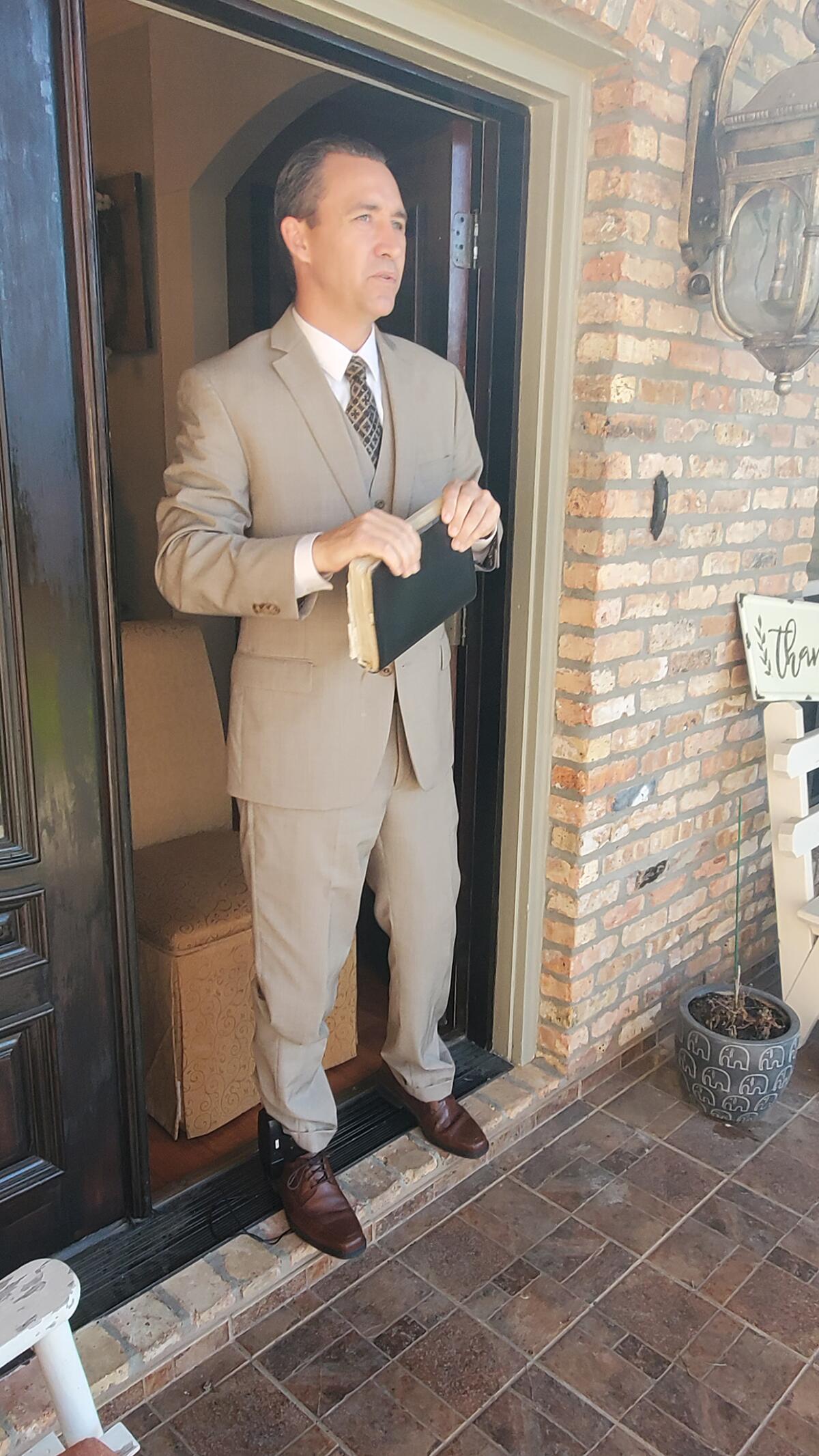 Spell stood in his doorway, clutching his Bible and saying goodbye to church members in anticipation of being arrested after the service Sunday.