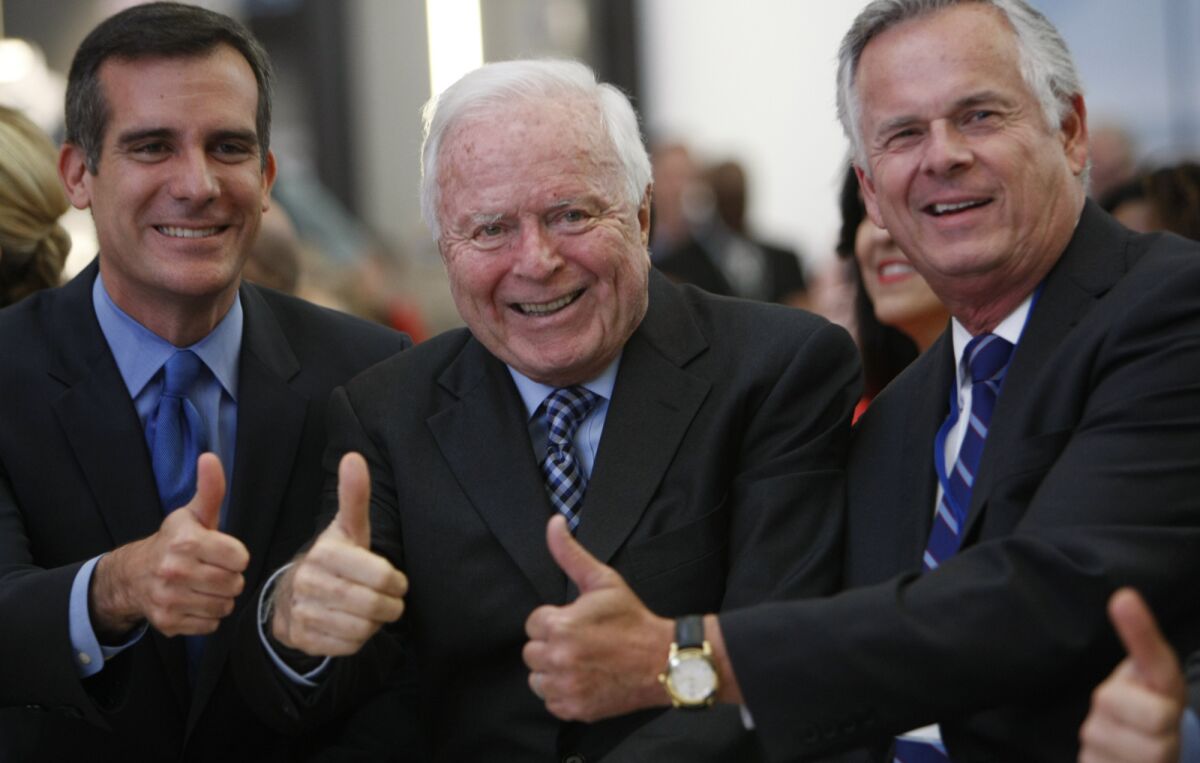 Los Angeles Mayor Eric Garcetti , left, with former mayors Richard Riordan and James Hahn in 2013 at the grand opening of the $1.9-billion Tom Bradley International Terminal at LAX. Riordan has come out in support of a measure to crack down on mega-developments across the city.