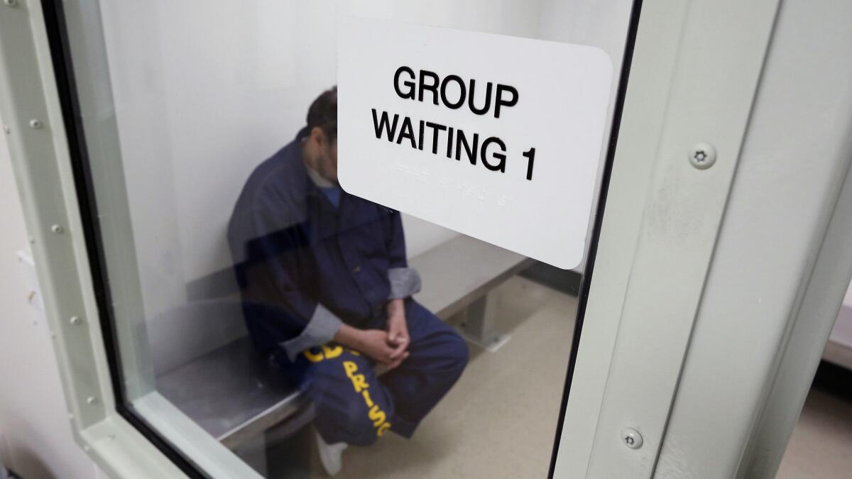 In this Feb. 14, 2013, photo, an inmate waits in a holding room at a mental health treatment unit at the California Medical Facility in Vacaville, Calif.