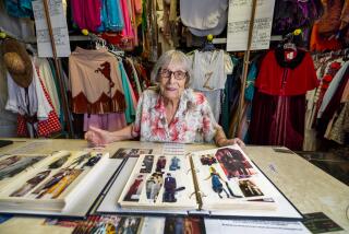 Santa Monica, CA - July 09: Ursula Borchet, a 90-year old Hollywood costumer, looks through scrapbooks of patrons wearing her costumes at her shop featuring a large collection of her hand-made costumes at Ursula's Costume shop in Santa Monica. Ursula is closing her shop. Her shop and workshop features costumes she's made for studios and shows and celebs over the years. Actress Kate Beckinsale has also become friends with Ursula and makes frequent visits to Ursula's Costume shop in Santa Monica Tuesday, July 9, 2024. (Allen J. Schaben / Los Angeles Times)