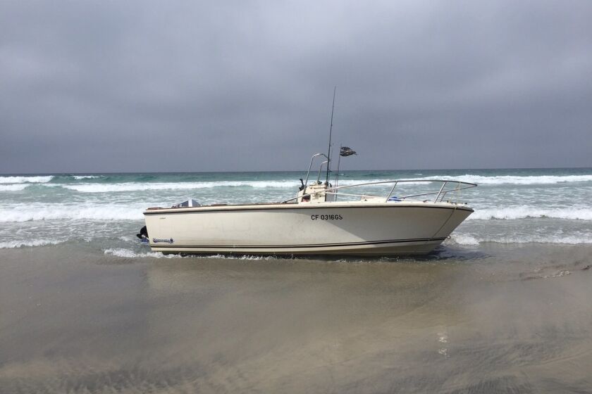 A boat washed ashore north Torrey Pines State Beach on Monday morning.
