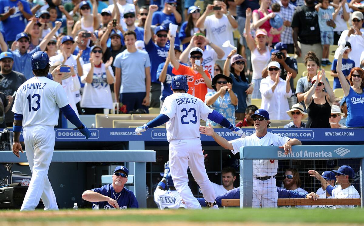 Fans and players celebrate a Dodgers home run on Sept. 7, 2014. Forbes ranked the team's value at $2.4 billion, second-highest in MLB.