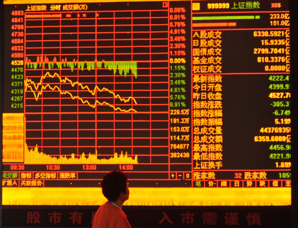 An investor observes the stock market at a stock exchange hall in China. Analysts said the recent stock market plunge there will have indirect effects on the U.S. economy.