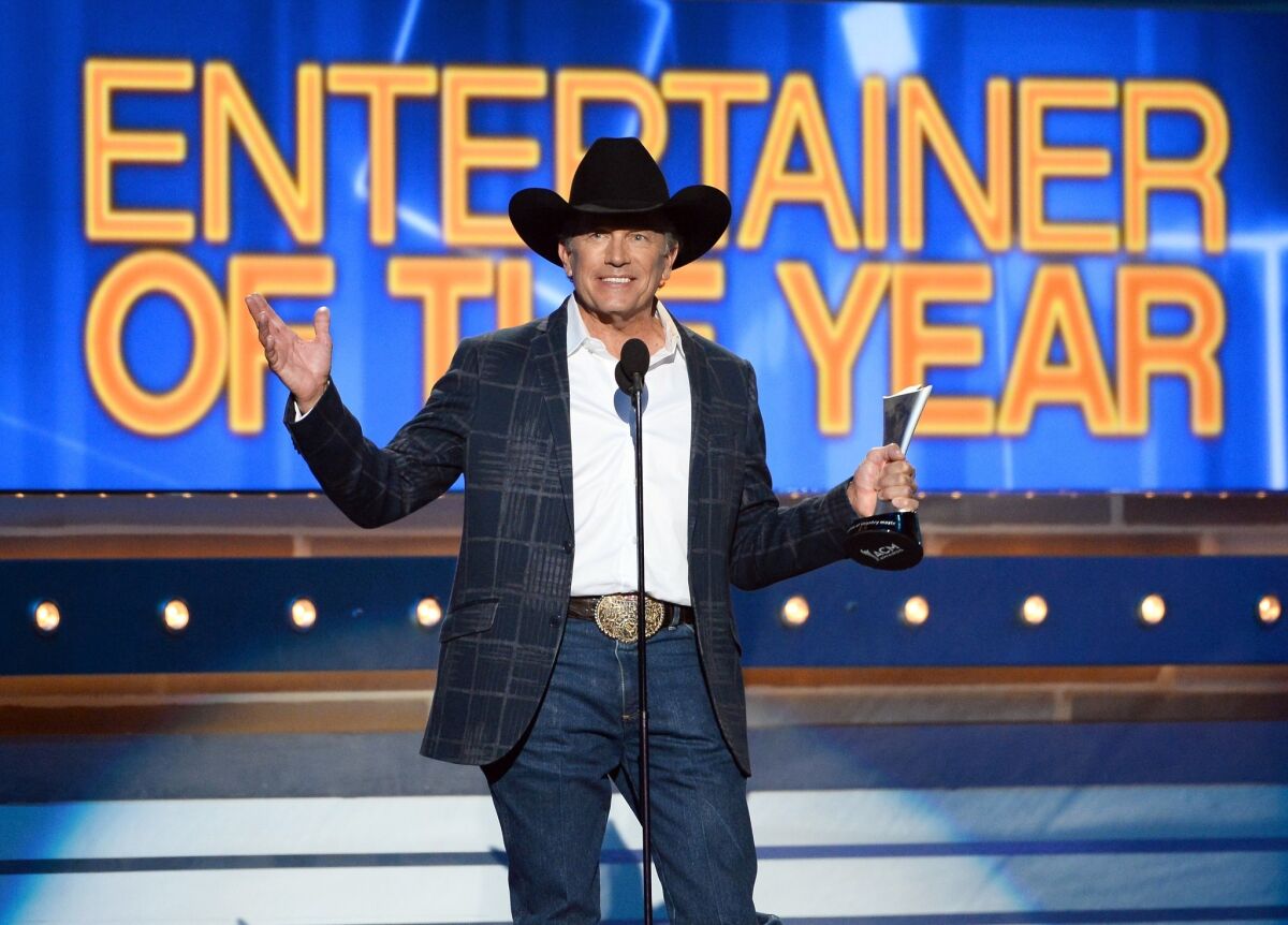 Singer/songwriter George Strait accepts the Entertainer of the Year award onstage during the 49th Academy Of Country Music Awards.