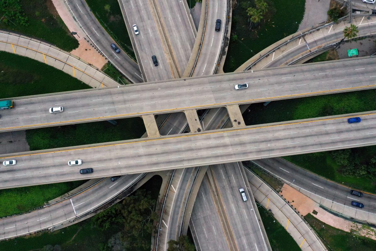 Aerial, top-down view of a mostly empty four-level freeway interchange