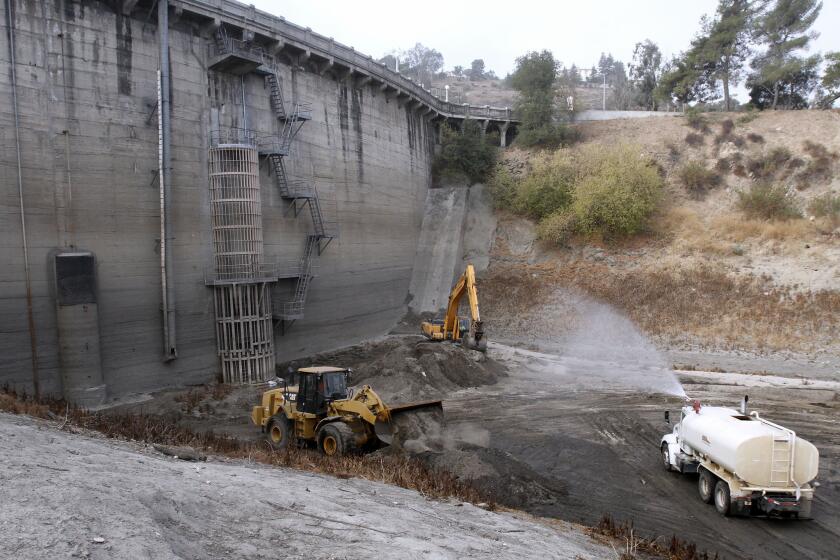Crews removed about 5,000 cubic yards of dirt from the base of Devil's Gate Dam at Hahamongna Watershed Park in Pasadena on Wednesday, Sept. 18, 2013. The Los Angeles County Department of Public Works released a draft environmental impact report in October 2013 that outlined five possible options for removing large amounts of sediment that built up in the basin after the 2009 Station fire and the storms that followed.