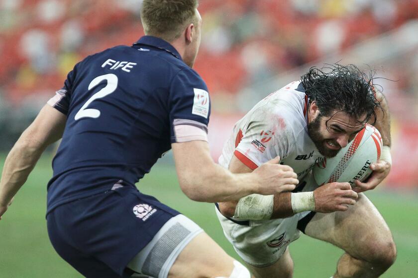 Nate Ebner of the United States tries to get past Dougie Fife of Scotland during the 2016 Singapore Sevens Bowl Final on April 17, 2016.