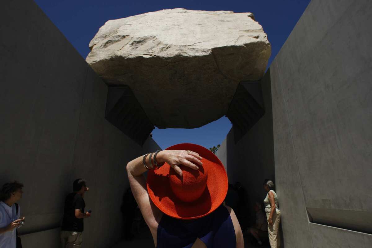 Alisa Katz seems amazed with artist Michael Heizer's "Levitated Mass," which opened to the public at the Los Angeles County Museum of Art on June 24, 2012.