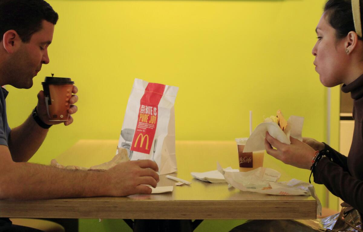 Analysts say breakfast is the only area with big growth potential in the fast-food industry, prompting chains to increase coffee offerings and other morning items. Above, Carlos Gonzalez and Elsa Guzman eat breakfast at a McDonald's restaurant in New York in 2012.