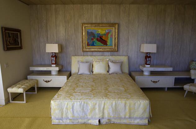 The master suite at the southeastern corner of the house has dual his-and-hers dressing rooms and bathrooms. It's bright and cheerful, furnished in shades of yellow with natural light pouring in from two sides. An indoor swimming pool originally adjoined the bedroom but later was turned into the Inwood Room.