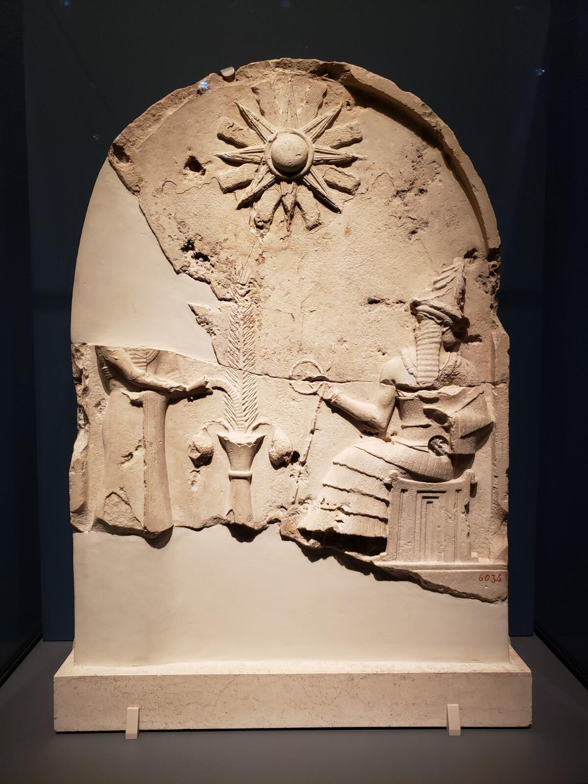 Fragments of limestone containing a bas-relief depiction of a god.