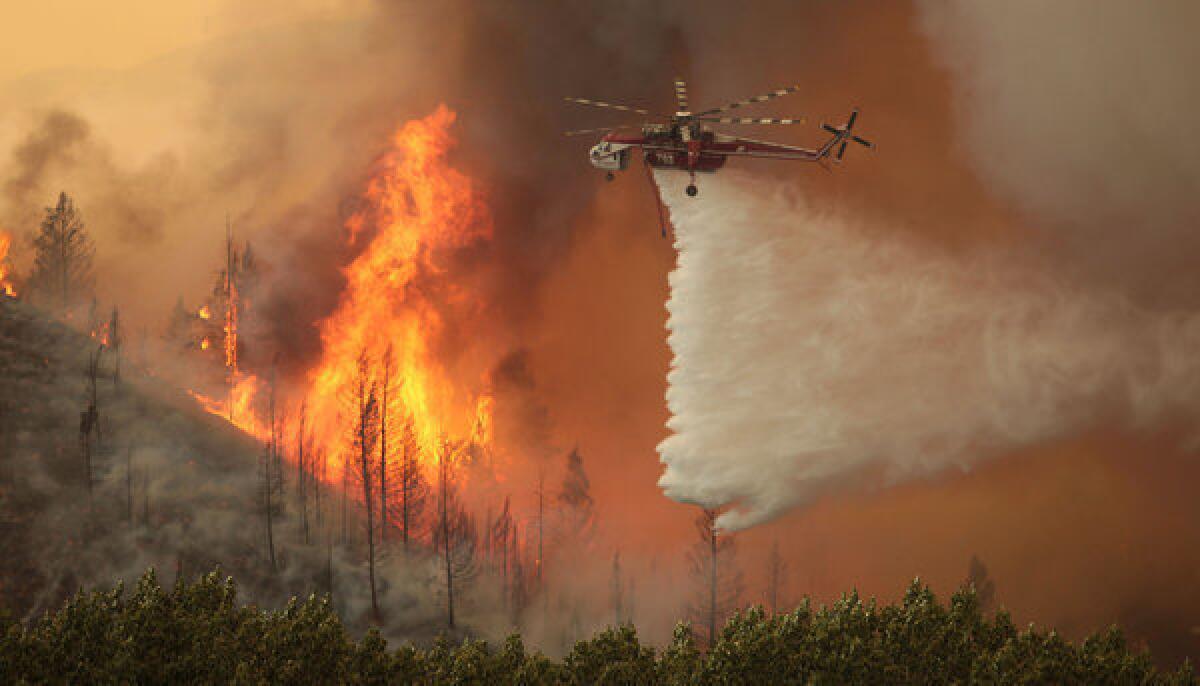 Helicopters battle the 92,000 acre Beaver Creek Fire on Friday north of Hailey, Idaho. Some 1,300 homes were evacuated, and the Sun Valley resort community was under pre-evacuation orders.
