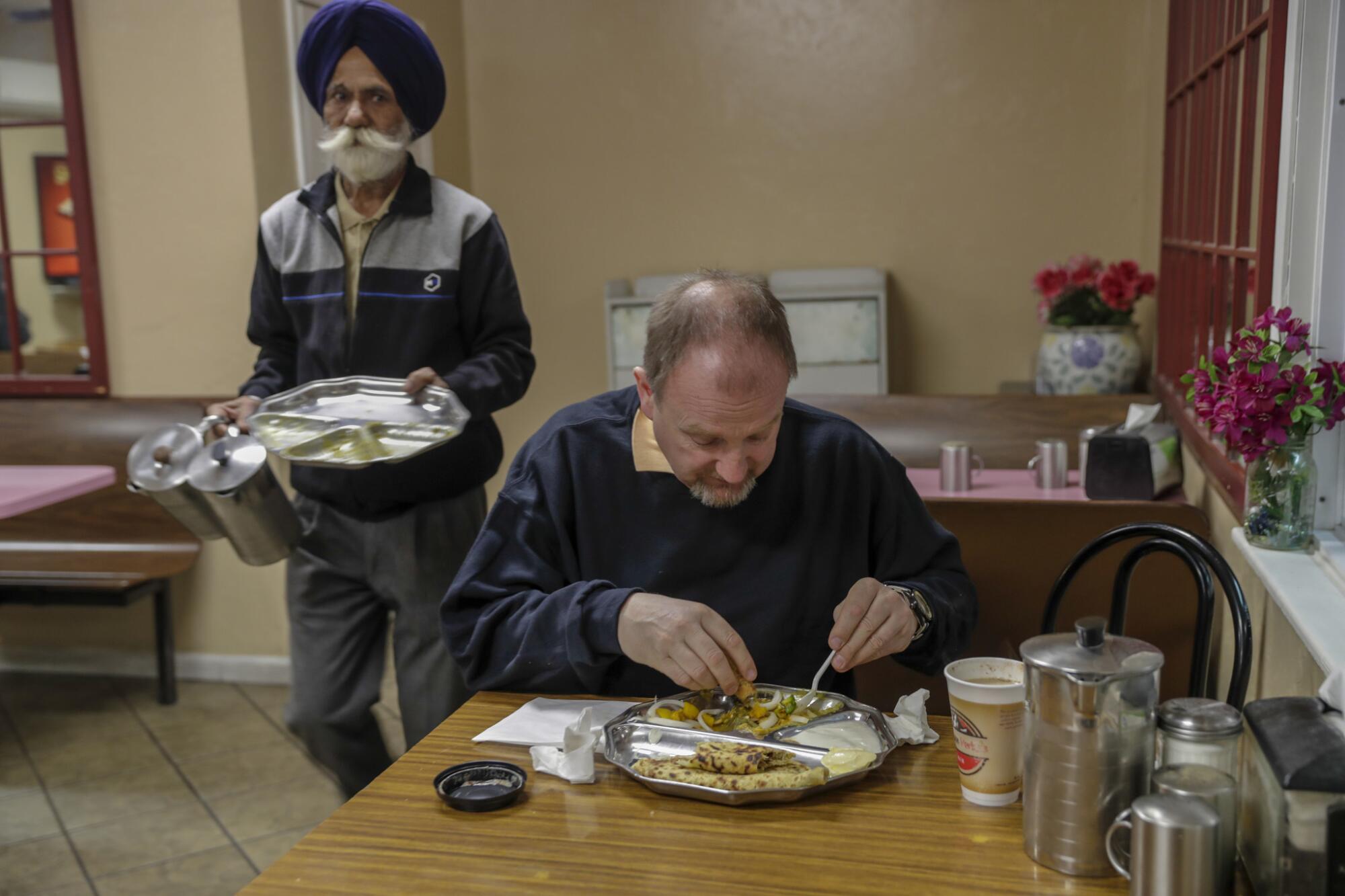 Edmund Paddon, a truck driver from Toronto, stops for dinner.