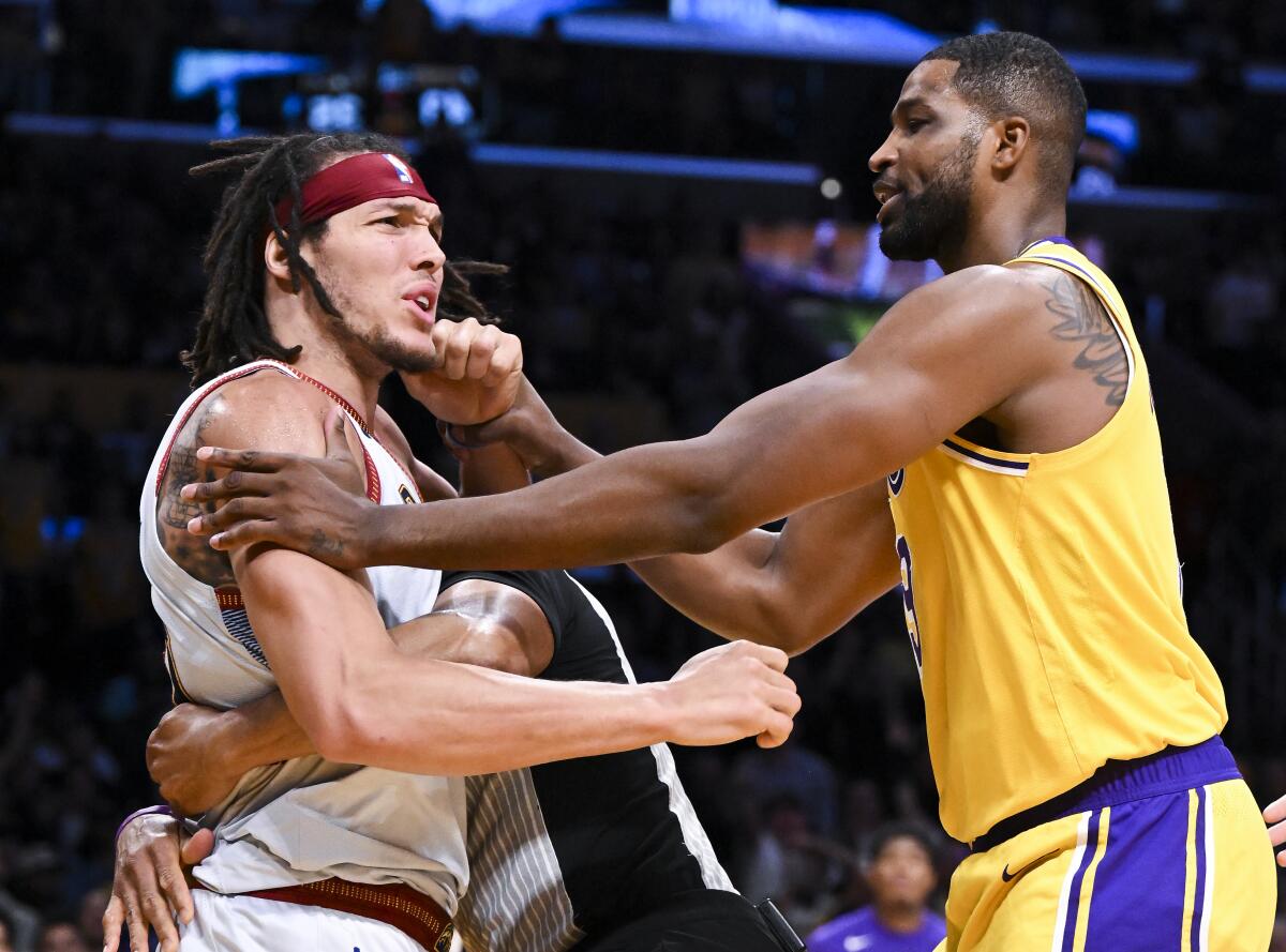 Lakers center Tristan Thompson, right, holds back Nuggets forward Aaron Gordon during a scuffle.