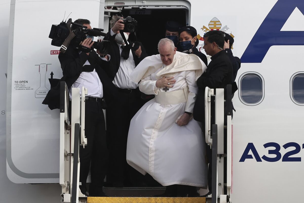 Pope Francis boards an aircraft departing from Eleftherios Venizelos International Airport in Athens, Greece, Monday, Dec. 6, 2021. Francis' five-day trip to Cyprus and Greece has been dominated by the migrant issue and Francis' call for European countries to stop building walls, stoking fears and shutting out "those in greater need who knock at our door." (AP Photo/Yorgos Karahalis)
