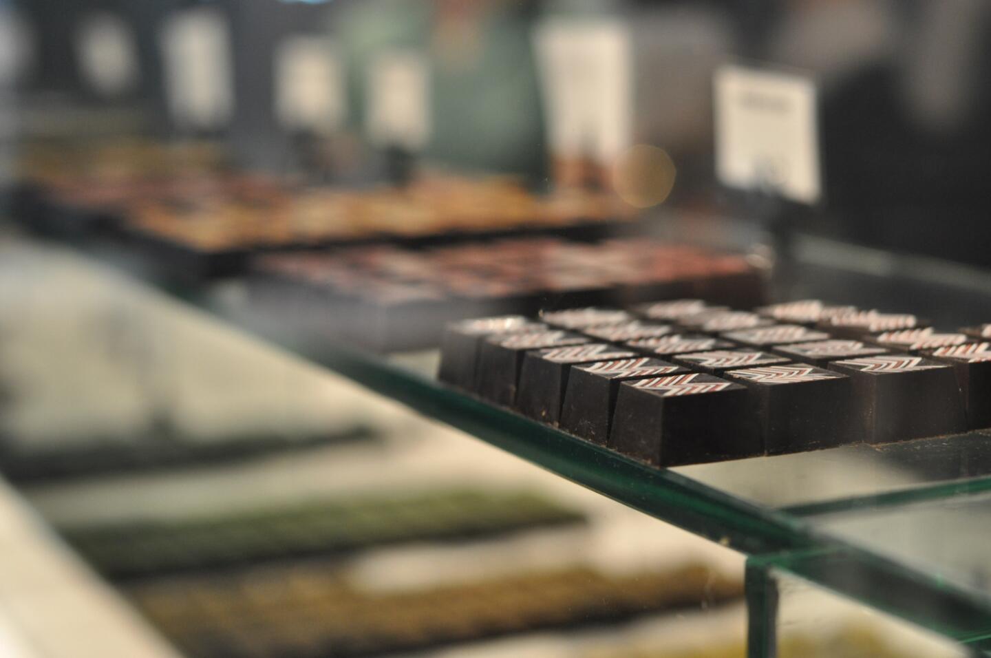 Inside the glass cases at Compartes are rows of custom-made chocolates.