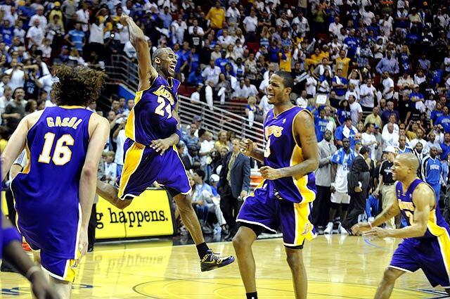 Lakers Kobe Bryant celebrates at the end of the game along wit Pau Gasol, Trevor Ariza and Derek Fisher after defeating the Magic in Game 5 of the NBA Finals in Orlando.