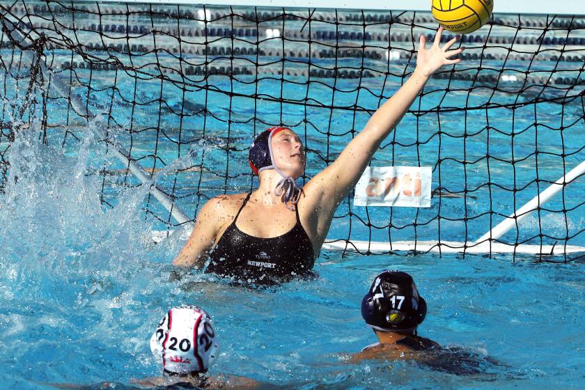 Newport Harbor's goalie Lydia Soderberg (1) reaches for the save during Newport Harbor High School girls' waterpolo team against Corona del Mar High School girls' waterpolo team in the Battle for the Bay waterpolo match at Newport Harbor High School in Newport Beach on Saturday, December 23, 2023. (Photo by James Carbone)