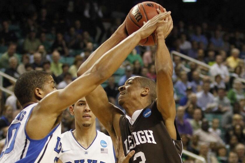 GREENSBORO, NC - MARCH 16: C.J. McCollum #3 of the Lehigh Mountain Hawks goes up for a shot over Andre Dawkins #20 and Austin Rivers #0 of the Duke Blue Devils in the first half during the second round of the 2012 NCAA Men's Basketball Tournament at Greensboro Coliseum on March 16, 2012 in Greensboro, North Carolina. (Photo by Streeter Lecka/Getty Images) ORG XMIT: 136578491 ** TCN OUT **