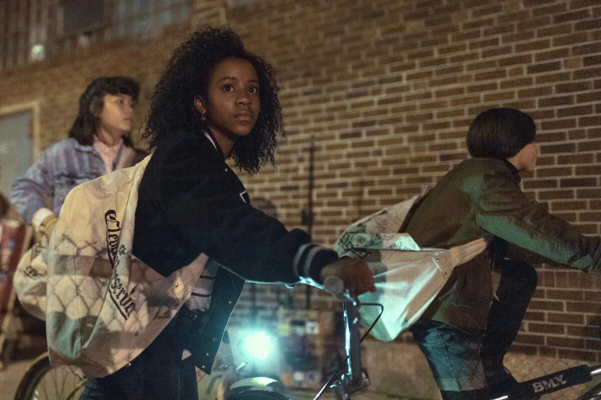 Three girls on bicycles delivering newspapers