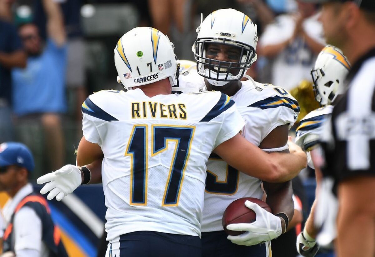 Chargers quarterback Philip Rivers congratulates tight end Antonio Gates after his 112th career scoring reception.