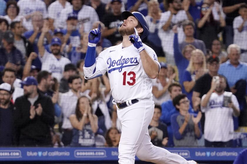 Los Angeles Dodgers' Max Muncy gestures before scoring after hitting a solo home run during the third inning.