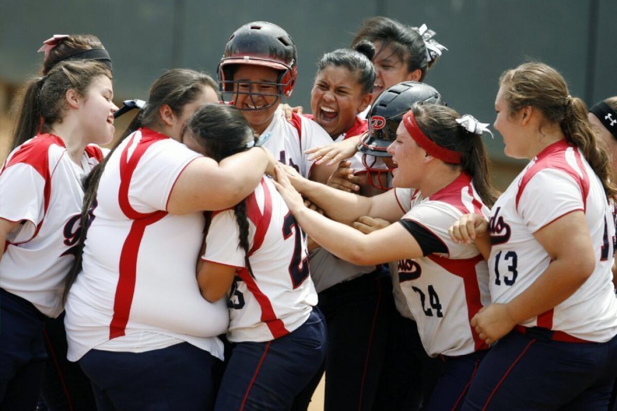 The Bellarmine-Jefferson softball team rejoices after Monique Ladini hits a home run in the CIF Division VI championship game against Mary Star.