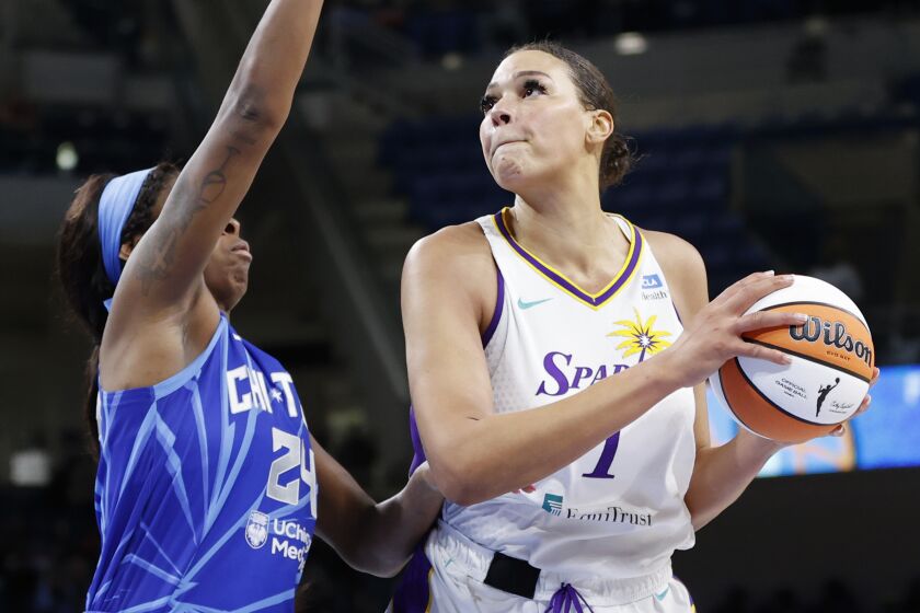 Los Angeles Sparks center Liz Cambage, right, drives to the basket against Chicago Sky.