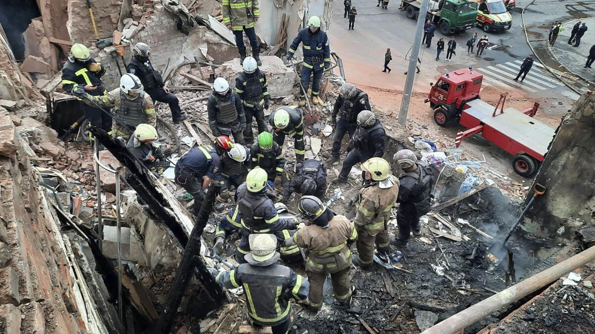Emergency workers searching for victims of Russian rocket attack in Kharkiv, Ukraine