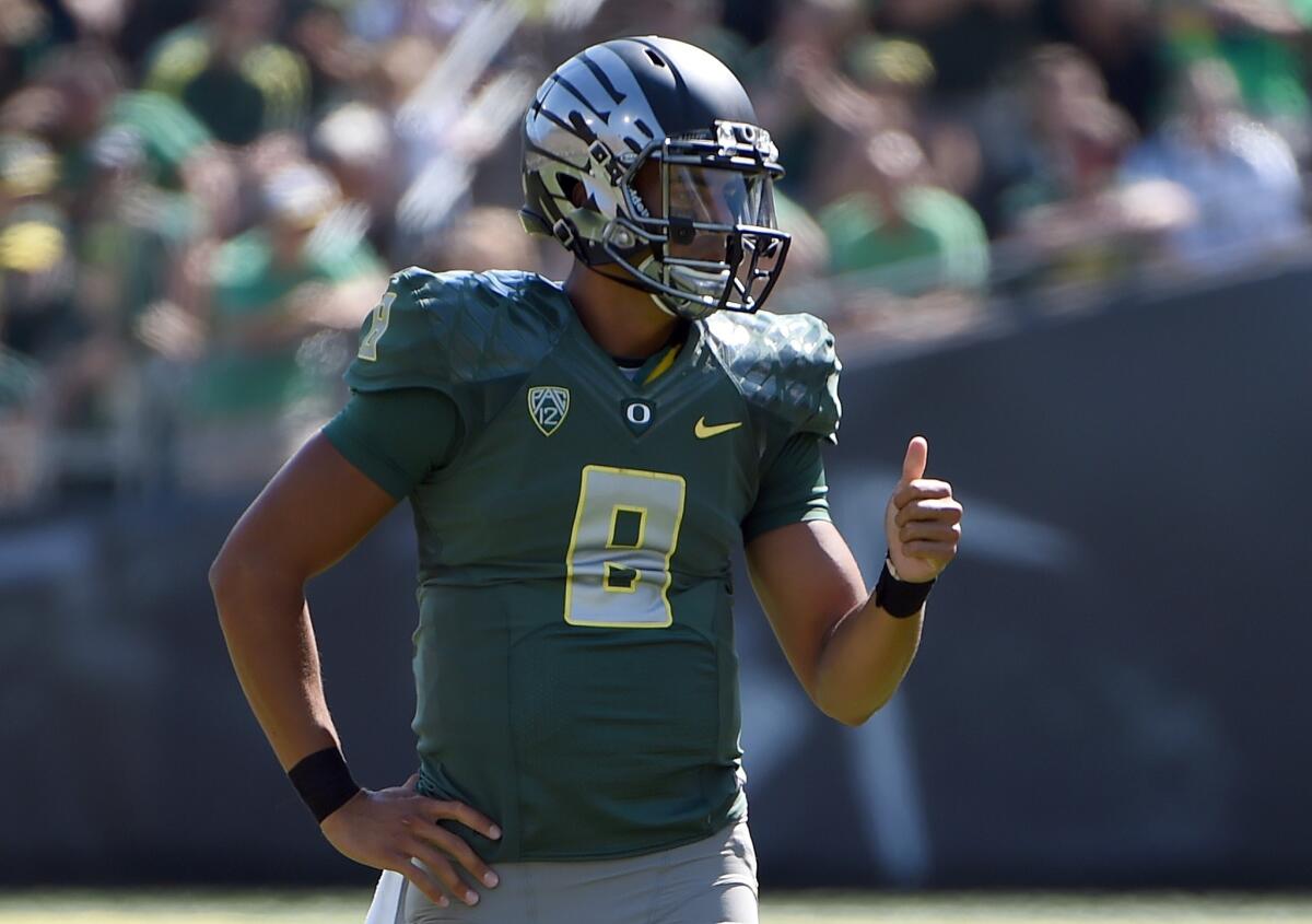 Oregon quarterback Marcus Mariota threw for two touchdowns and ran for two more in the Ducks' 48-14 win Saturday over Wyoming at AUtzen Stadium.