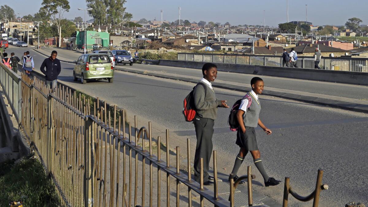 Children walk to school at Alexandra township in Johannesburg, South Africa. Lufthansa is offering an $883 round-trip airfare from LAX to Johannesburg for travel beginning in October.