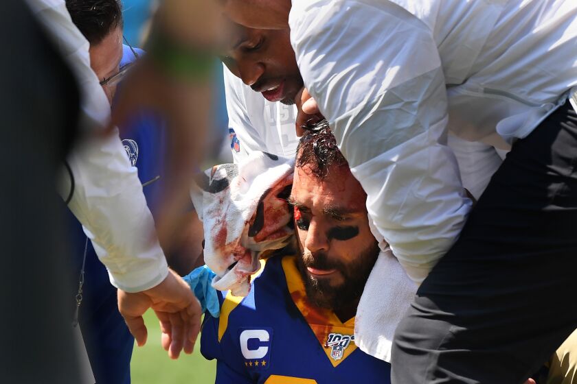 CHARLOTTE, NORTH CAROLINA SEPTEMBER 8, 2019-A bloody Eric Weddle of the Rams is attended to by staff after atackle against the Panthers inthe 2nd quarter at Bank of America Stadium in Charlotte Sunday.(Wally Skalij/Los Angeles Times)