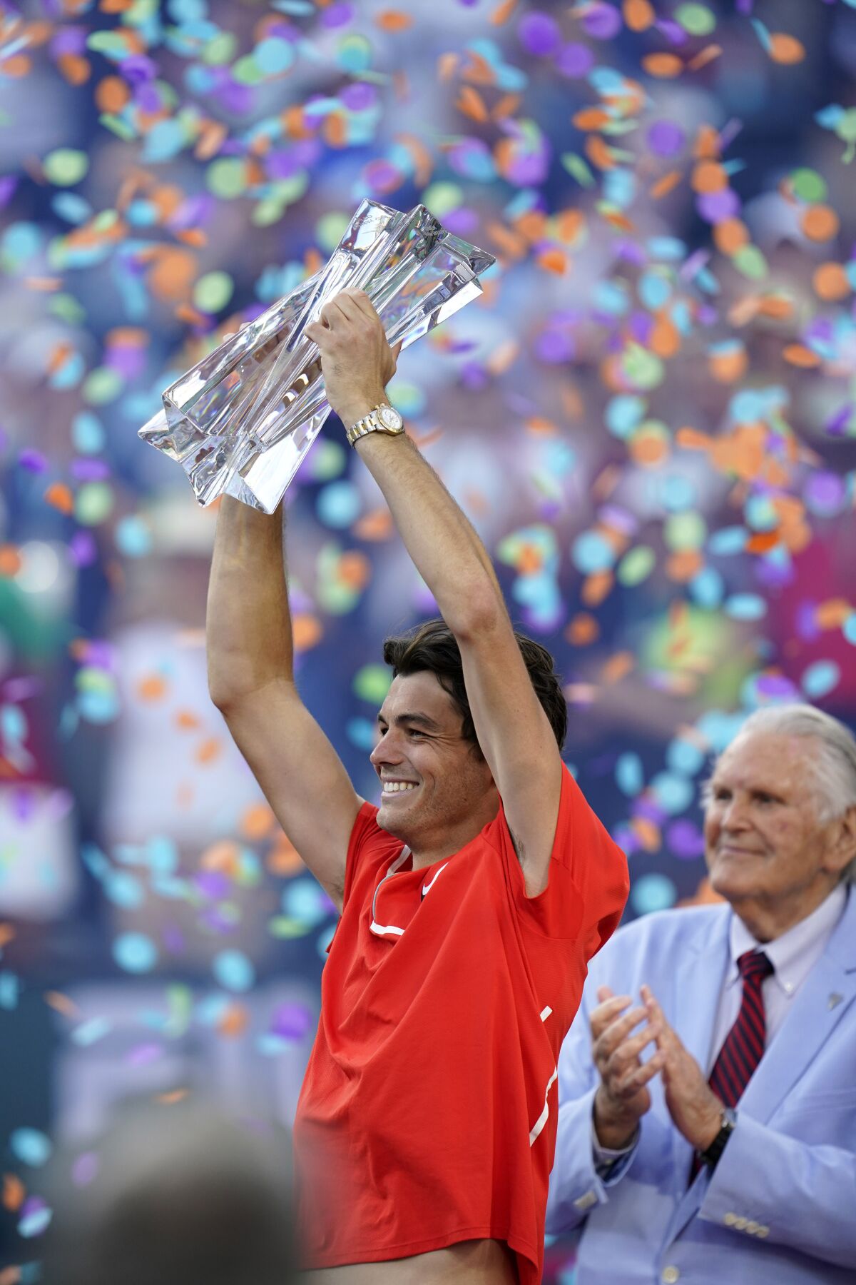 Taylor Fritz holds up his trophy after winning the men's singles finals at the BNP Paribas Open tennis tournament in 2022.