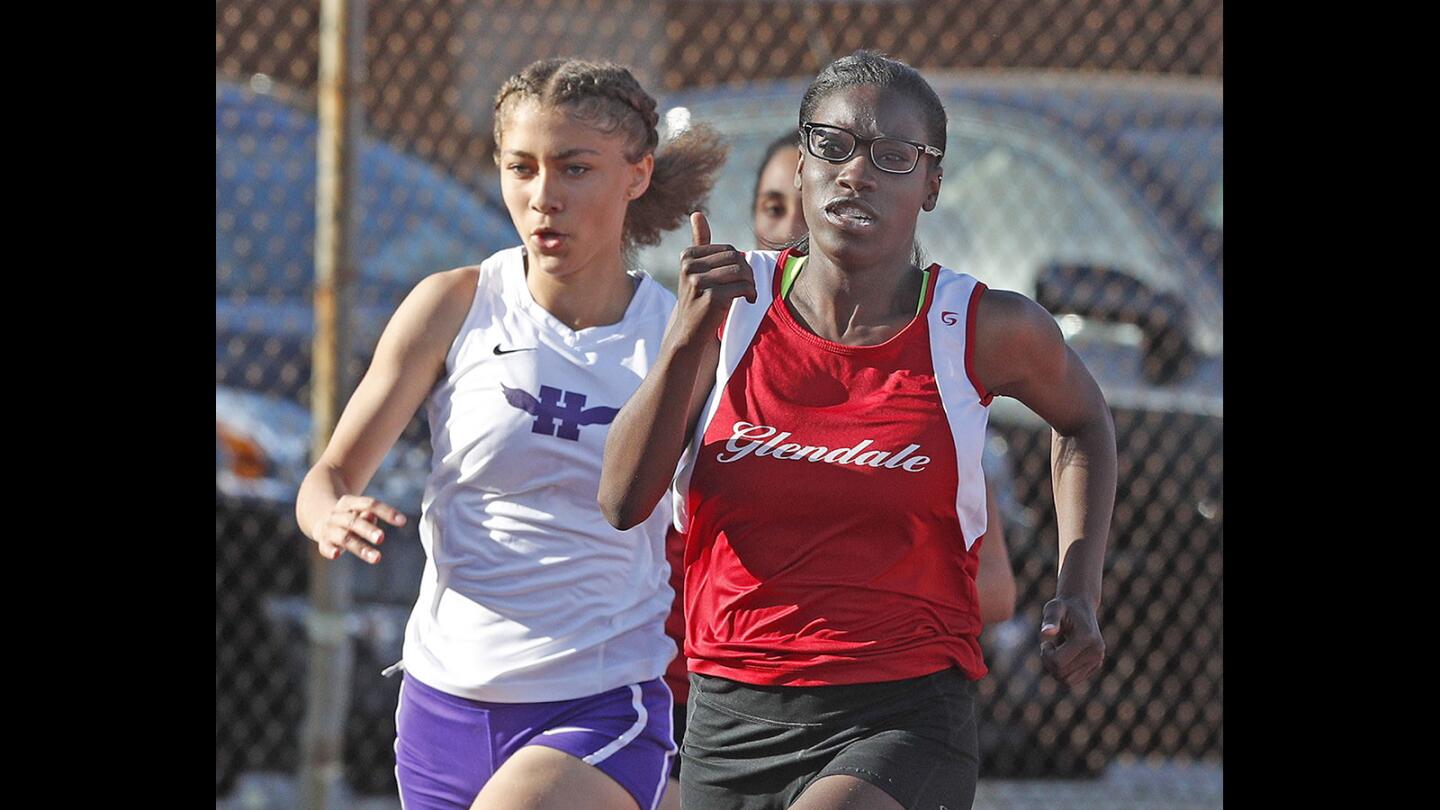 Glendale's Kendall Gaskin leads Hoover's Jazzmin Simmons in the 200 in a Pacific League track meet at Glendale High School on Wednesday, April 18, 2018. The winner of the meet takes home a victory bowl that the school holds onto until they meet again next year.