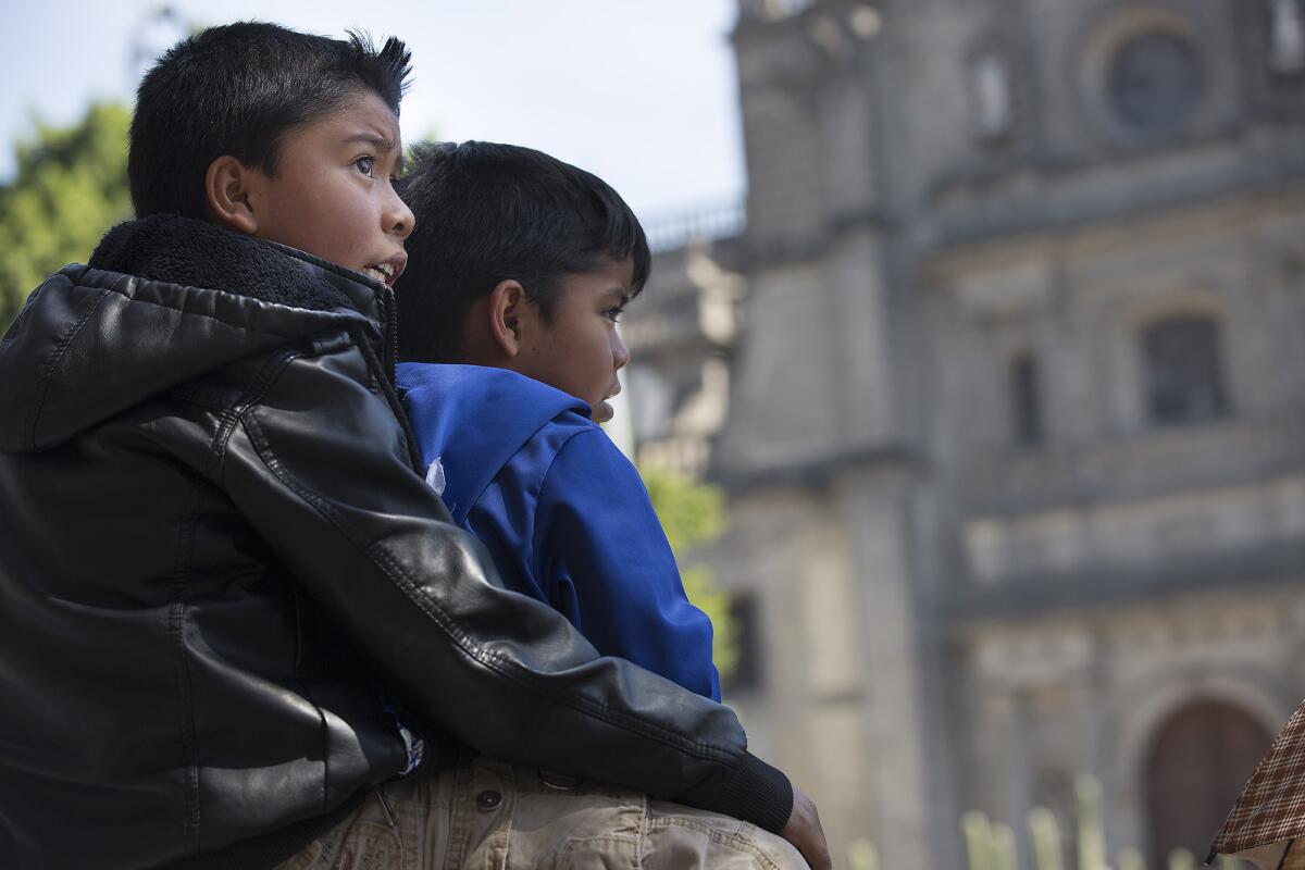 Young boys wait to catch a glimpse Pope Francis during his visit in Mexico City, Calif., on Feb. 13, 2016.