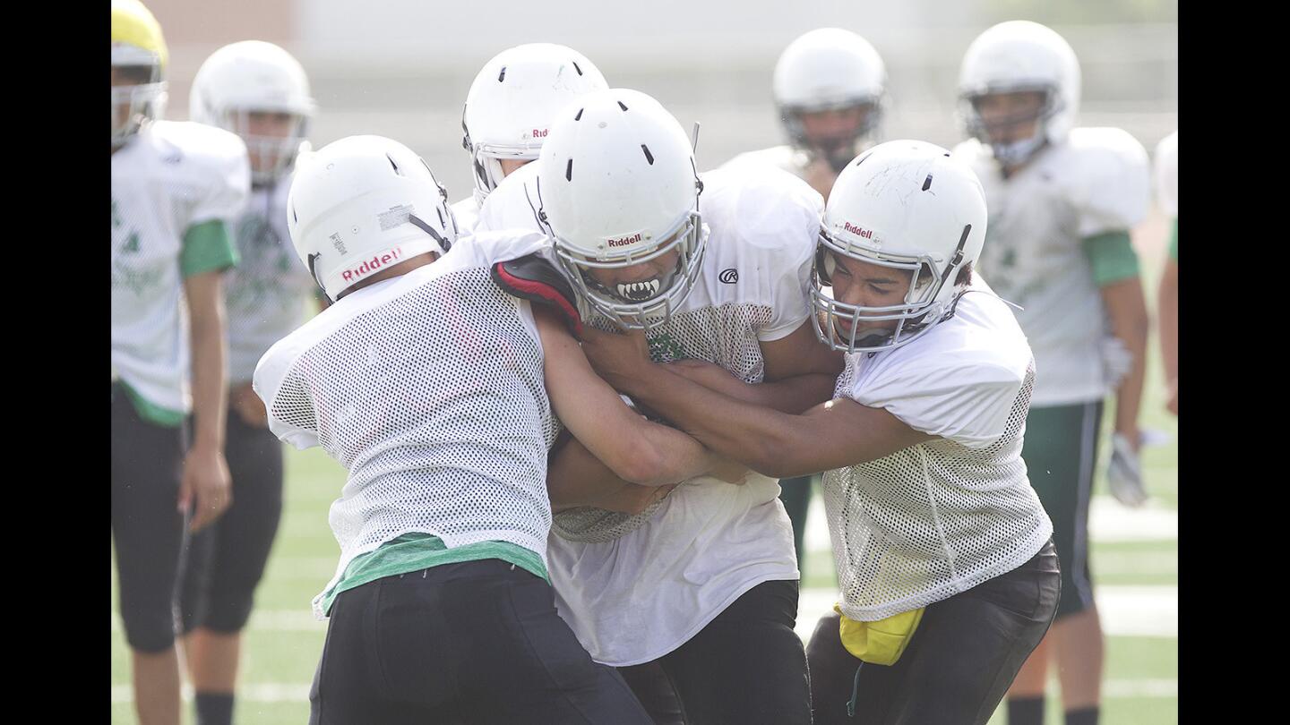 Costa Mesa football players go through full speed hitting drills during recent practice at Costa Mesa High.