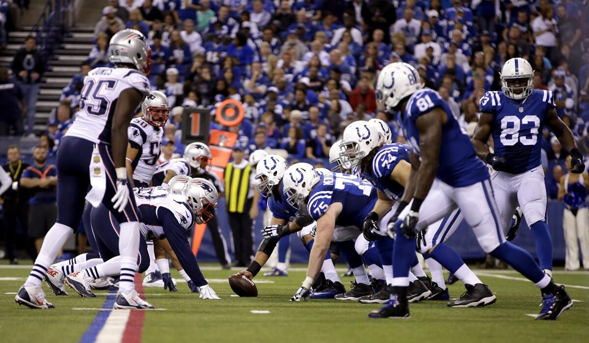 Members of the New England Patriots and Indianapolis Colts on the line of scrimmage in the second half of a game on Sunday.