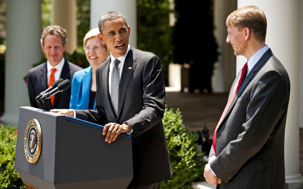 President Obama nominates Richard Cordray, right, to lead the Consumer Financial Protection Bureau in 2011. Watching are Sen. Elizabeth Warren (D-Mass.), then a special advisor to Obama, and former Treasury Secretary Timothy F. Geithner.